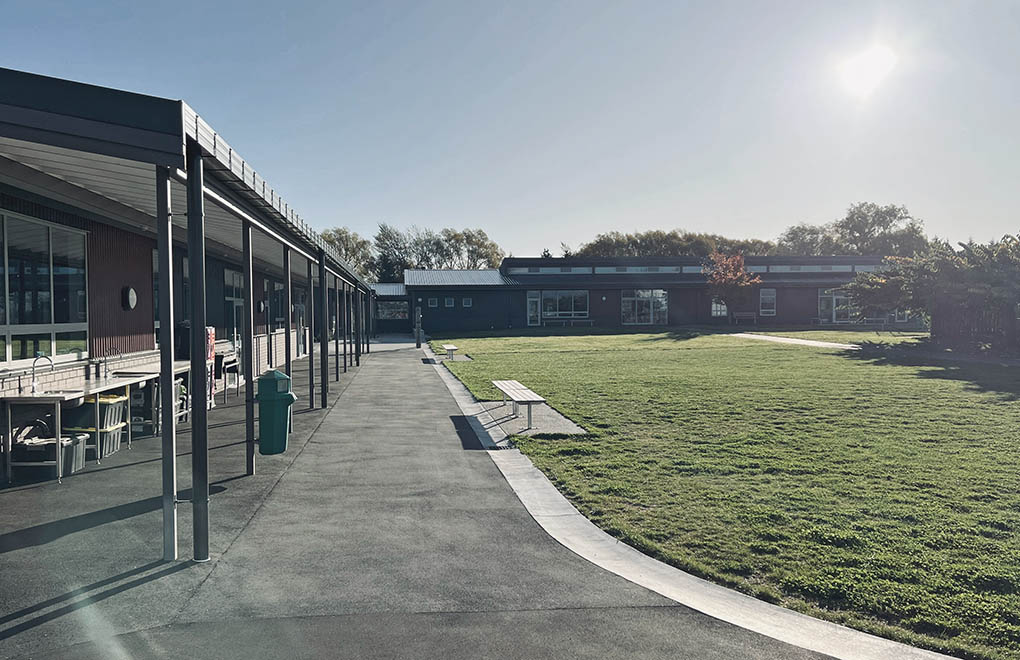 Central green space at Maniototo Area School framed by covered walkways and teaching buildings.