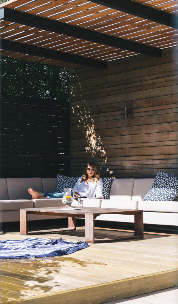 Timber pool cabana with built-in lounge seating beside the Freemans Bay swimming pool.