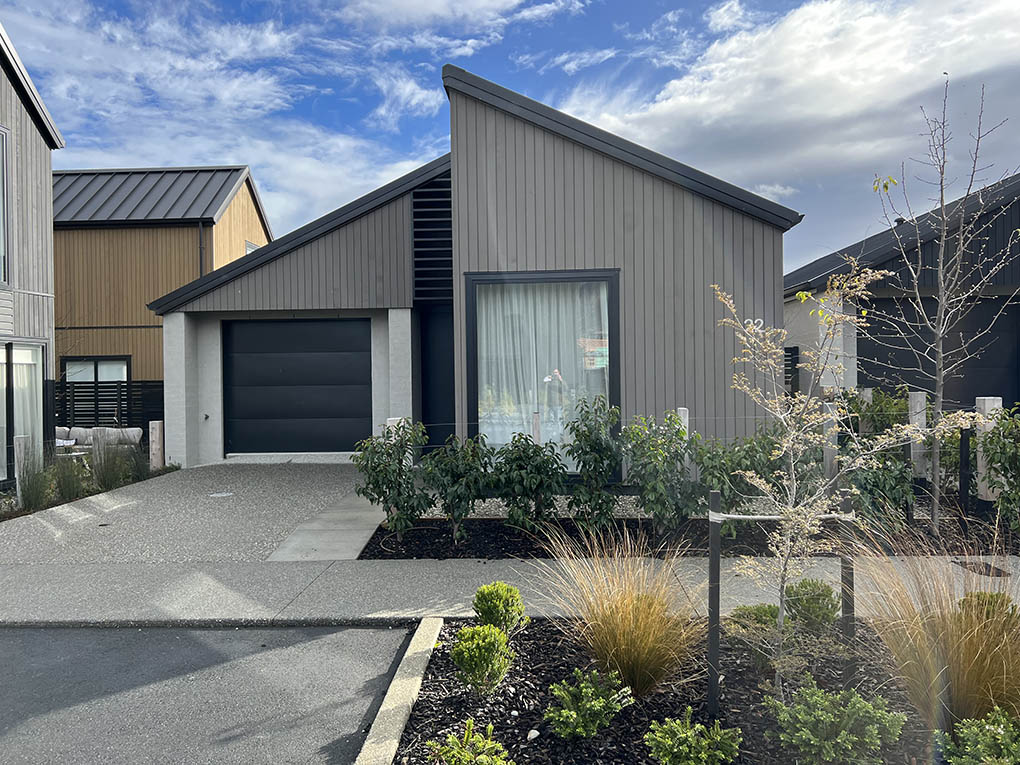 Contemporary home at Station View with integrated driveway paving, entry planting and native grasses.