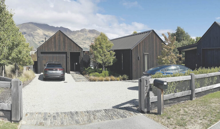 Wānaka Barn House with a gravel arrival court and structured native planting.